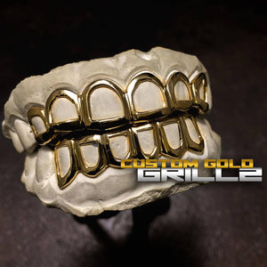 Solid Gold Open Face Custom-Made Grillz including Logo on Creative Background
